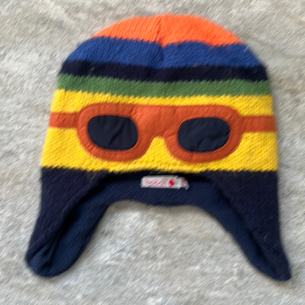 Very cute kids winter hat with stripes and goggle design.